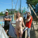 Young girl posing naked at road market