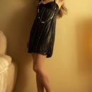 A sultry Una Piccola ina black lingerie dress and strappy stilettos that compliments her lean physique