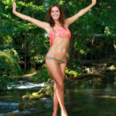 Fernanda poses in her two-piece bikini by the river, her slim silhouette with sexy, leans legs stands out
