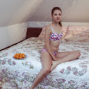 Jasmina strisp her flowery lingerie baring her slender body with smooth, wet   pussy as she poses on the bed.