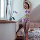 Jasmina strisp her flowery lingerie baring her slender body with smooth, wet   pussy as she poses on the bed.