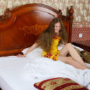 Teen Nicole K with long hair in bed