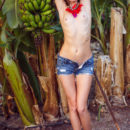 A flirty and playful Kalisy showing off her perky tits and meaty ass in the middle of a banana plantation