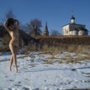 Bare girl dancing on the snow