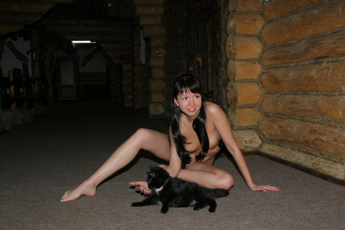 Brunette Alena T plays with black kitten