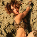 Busty teen in sexy leopard dress on the rocks
