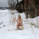Young blonde without clothes on frozen river
