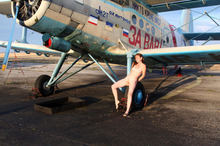 Youthfull russian redhead dame walks nude at small aerodrome