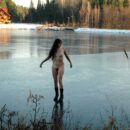 Smiling girl posing on frozen lake