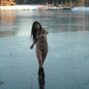 Smiling girl posing on frozen lake