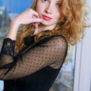 Diana Bronce flaunts her slender body with curvy hips and sexy legs as she poses on the elegant chair.