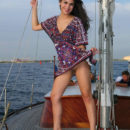 Naked brunette posing on yacht