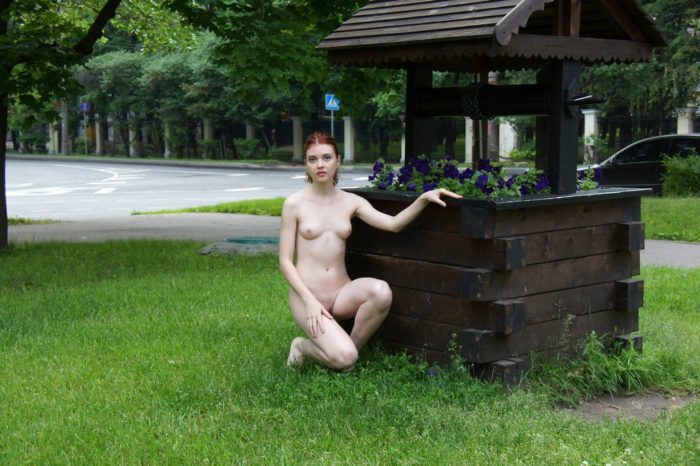 Naked teen Orabelle A at a flower bed outdoors