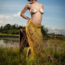 Pammie Lee sensually poses among the grassy field as she bares her curvy body and trimmed pussy.