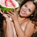 Emmy playfully poses with a watermelon on her sweet body.