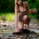 Teen Amelie with sporty body posing at forest river