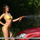 Galina A shows off her wet, sexy bod as she washes the car.
