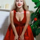 Genevieve Gandi in a sexy black dress, red stiletto shoes and matching red lipstick