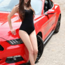 Hot brunette Li Moon and red Ford Mustang