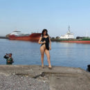 Naked russian girl walks behind fishermen