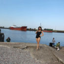 Naked russian girl walks behind fishermen