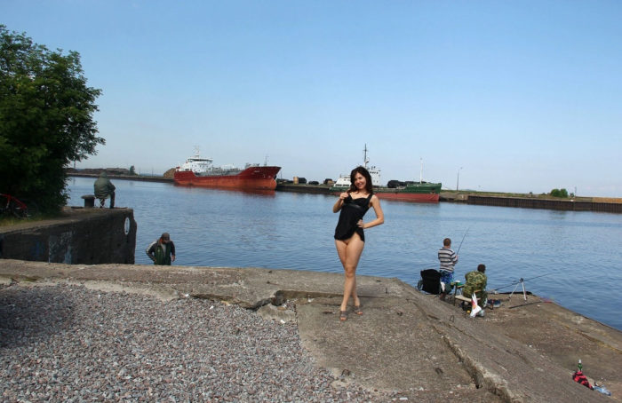 Naked russian girl walks behind fishermen