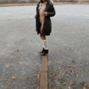 Russian teen walks on frozen lake in boots and hat