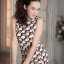 Ulia sensually poses by the piano baring her hairy pussy.