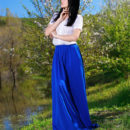 Indiana Blanc strips her long skirt and white blouse baring her slender body with   small tits and pink pussy as she poses in the outdoors.