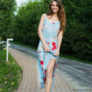 A sweet-smiling Olwen debuts by spreading her legs wide open, showcasing her svelte legs and shaved pussy