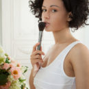 Pammie Lee bares her curvy hips and trimmed pussy on the sofa.