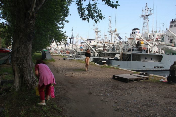 Russian girl Vika undresses near fishermen