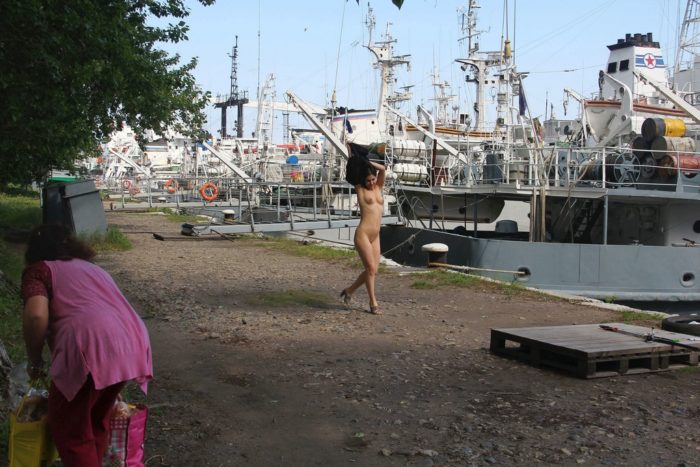 Russian girl Vika undresses near fishermen