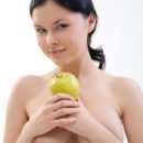 Brunette Gia B posing with an apple