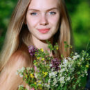 Honey Liz shows off her petite body and pink pussy in the forest.