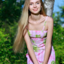 Honey Liz shows off her petite body and pink pussy in the forest.