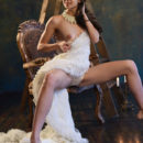 Starlet strips her white long gown baring her tight sexy body, yummy ass and smooth pussy as she pose on the chair.