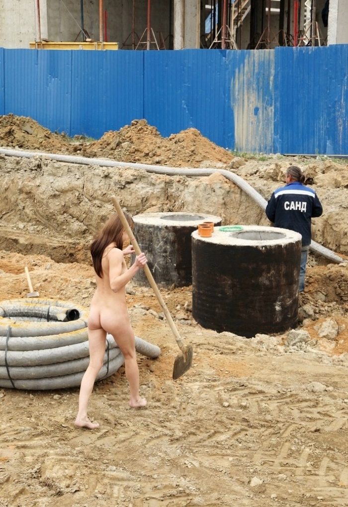A girl without clothes helps workers at a construction site