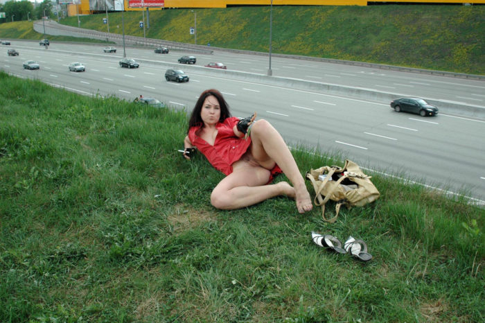 Beautiful brunette fucks herself with a vibrator next to the highway