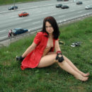 Beautiful brunette fucks herself with a vibrator next to the highway