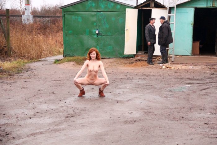 Russian redhead posing naked on railway