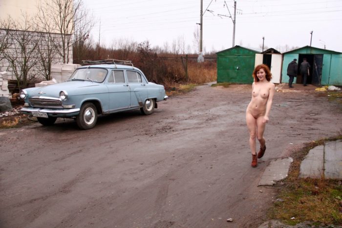 Russian redhead posing naked on railway
