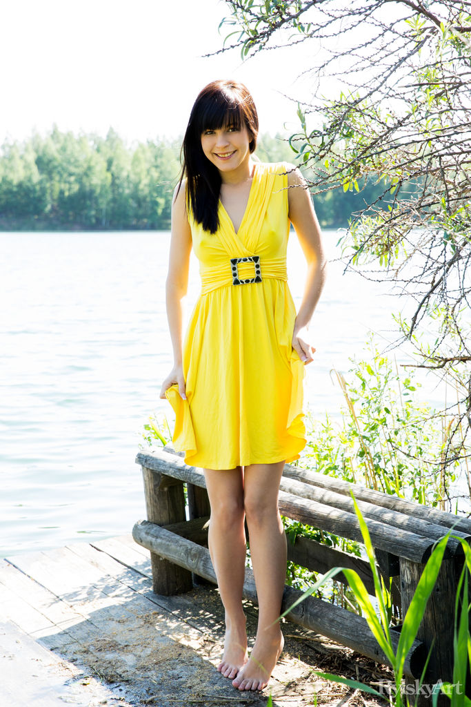 Brunette Zelda B posing in yellow dress