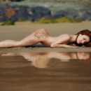 Redhead babe Night A posing in wet sand