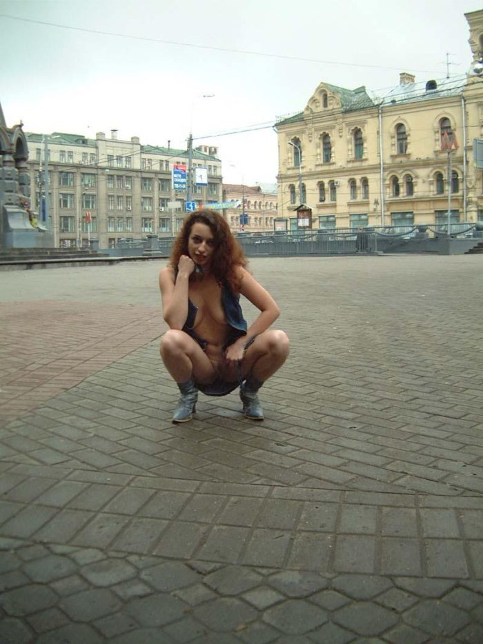 Curly girl walks in boots at Moscow streets