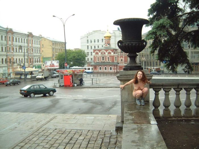 Curly girl walks in boots at Moscow streets
