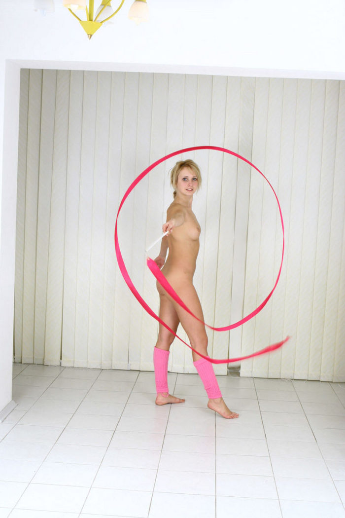 Gymnastics blonde girl posing in pink gaiters