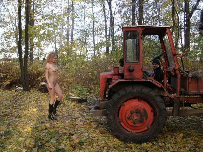 Naked blonde posing with cemetery workers