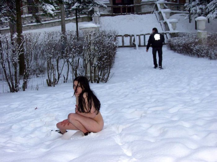 Naked brunette posing at winter park