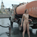 Naked young girl posing with workers